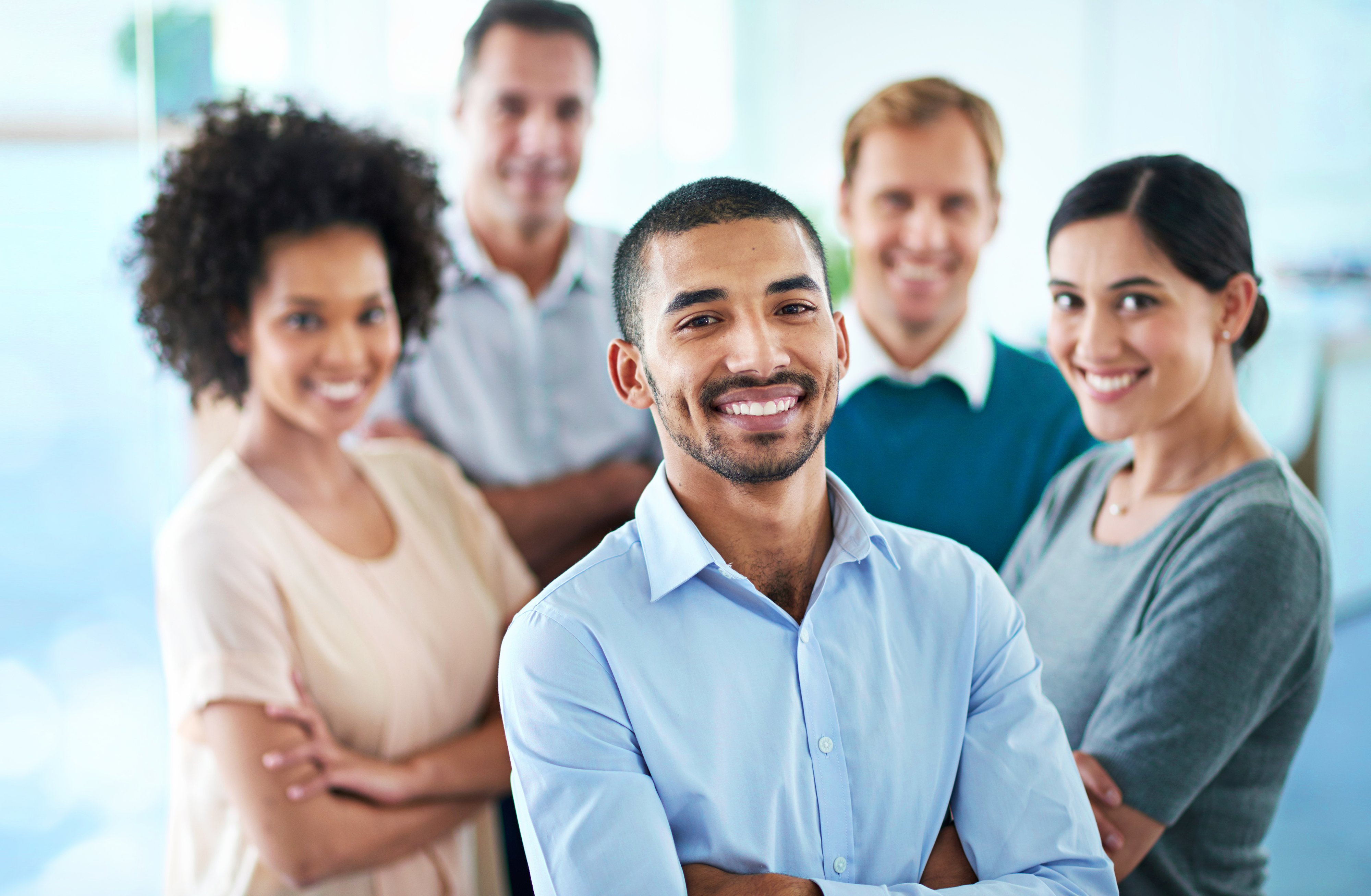 Group of diverse colleagues standing in their office