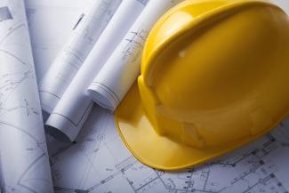 Close up of Safety Helmet And Construction Plans